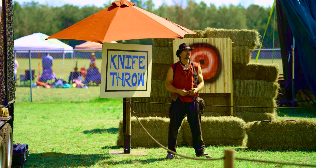 knife throw game of the Renaissance faire banner